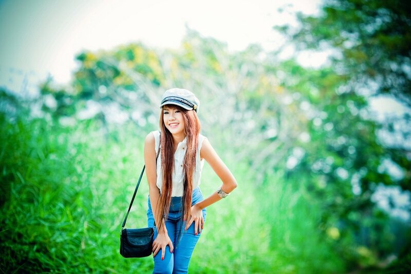 woman in cap smiling outdoors