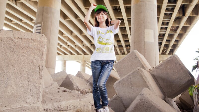 Woman in cap under a bridge