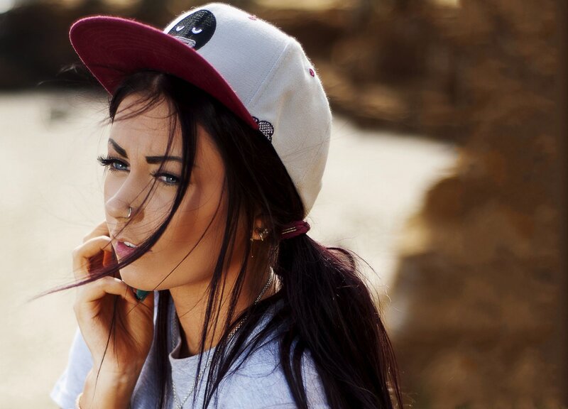woman in cap with wind-blown hair