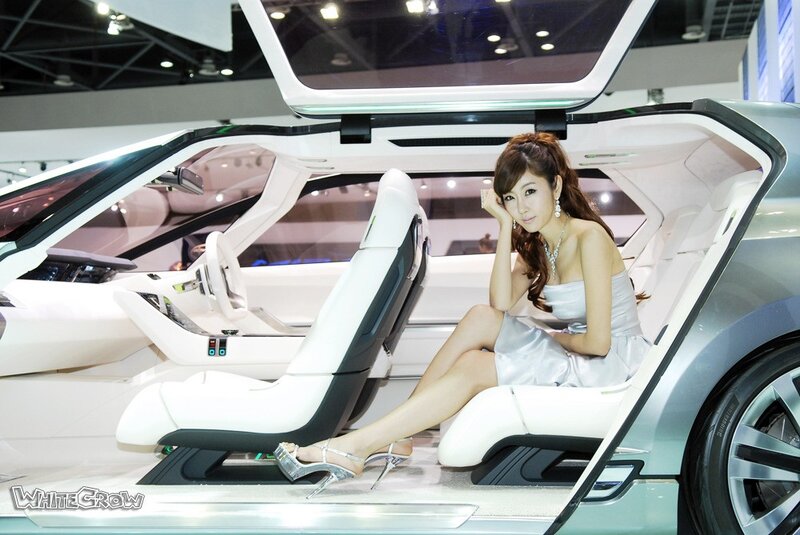 Woman in car at auto show
