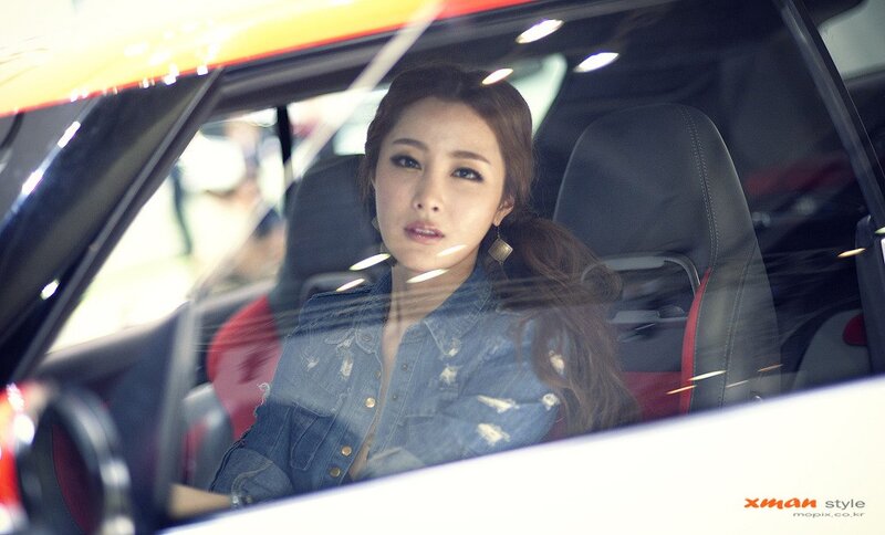 woman in car at auto show
