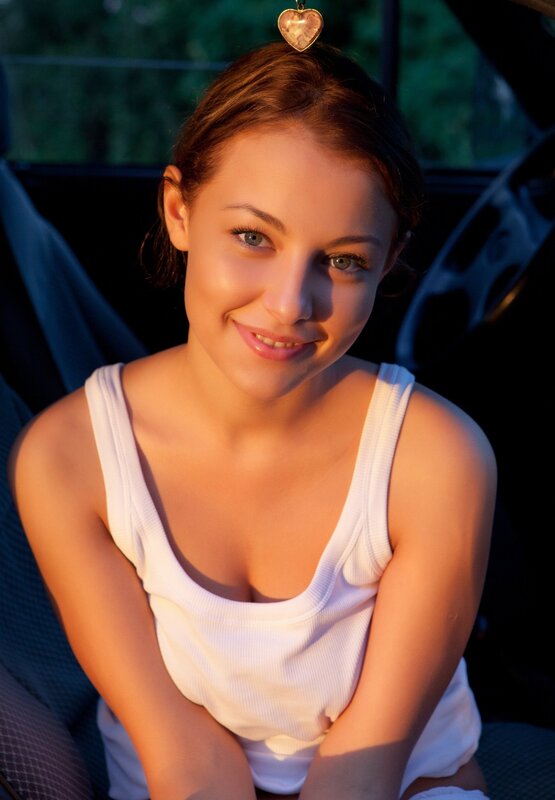 woman in car at sunset