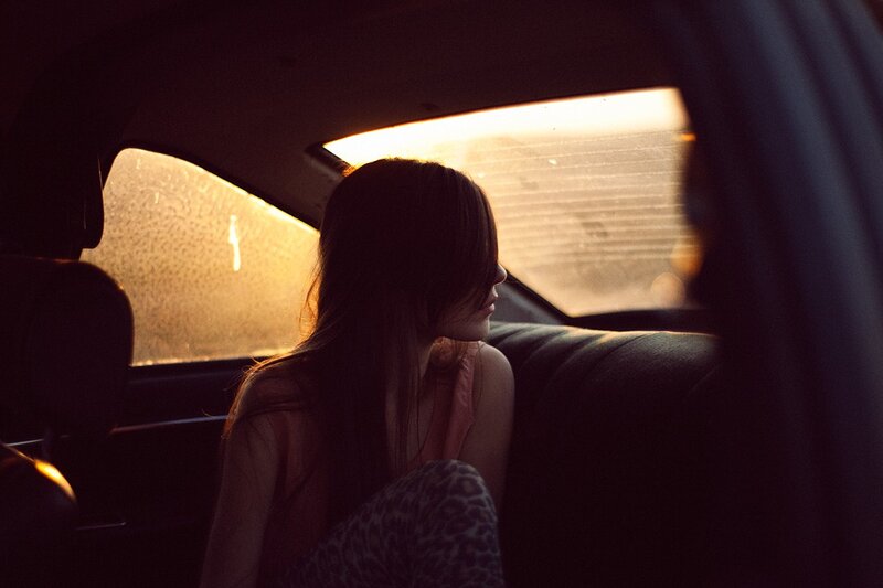 woman in car at sunset