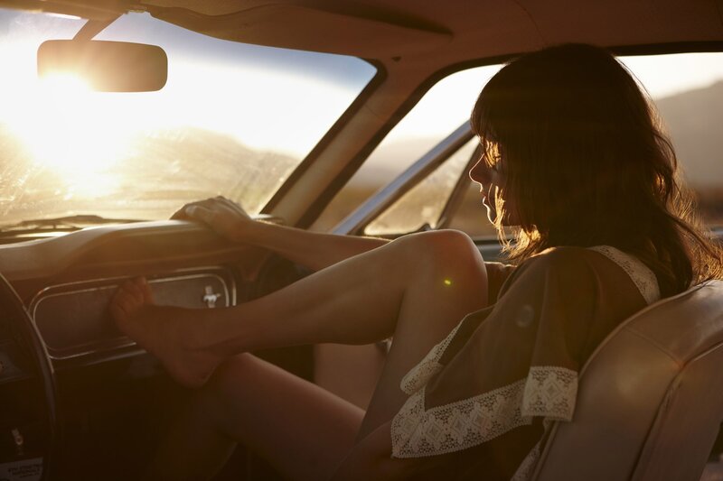 woman in car at sunset