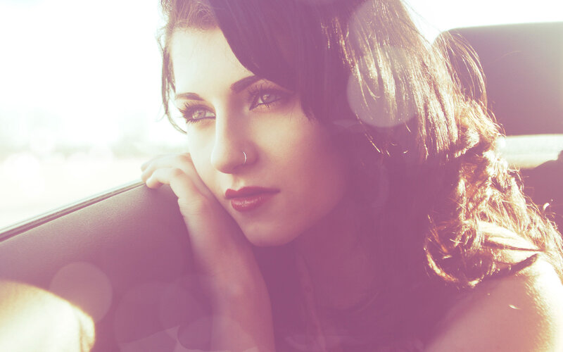 woman in car at sunset
