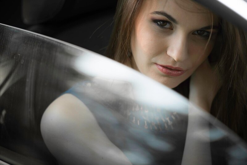 woman in car looking at camera