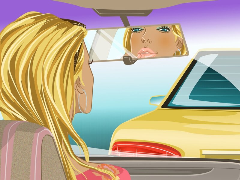 woman in car looking at mirror