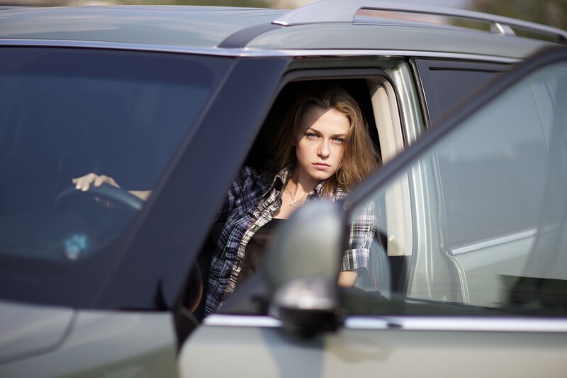 woman in car looking out window