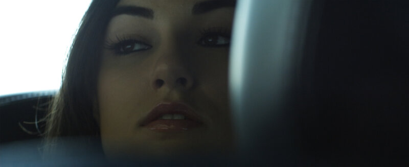 woman in car looking up