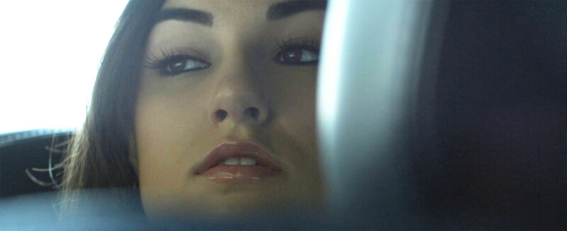 woman in car looking up