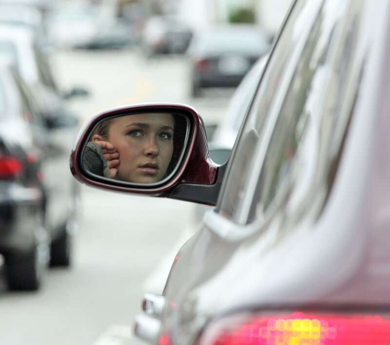 woman in car mirror