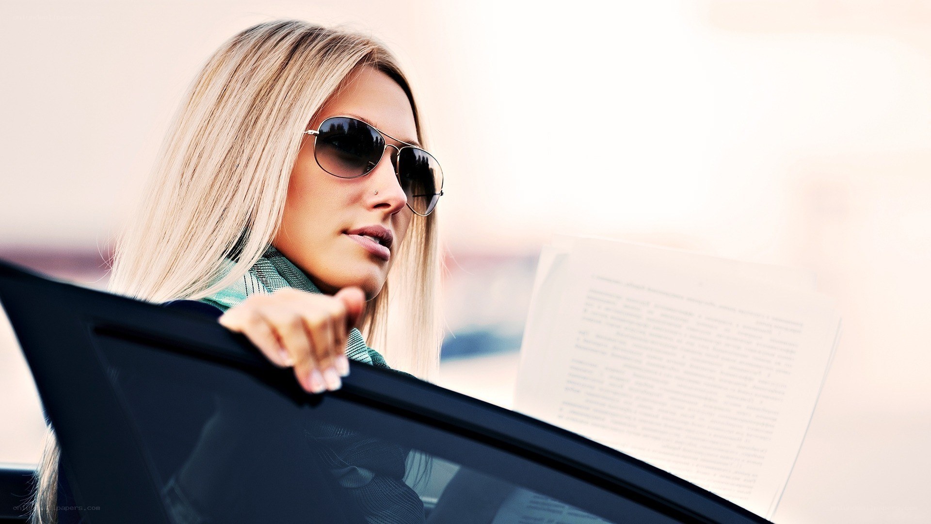 woman in car reading document