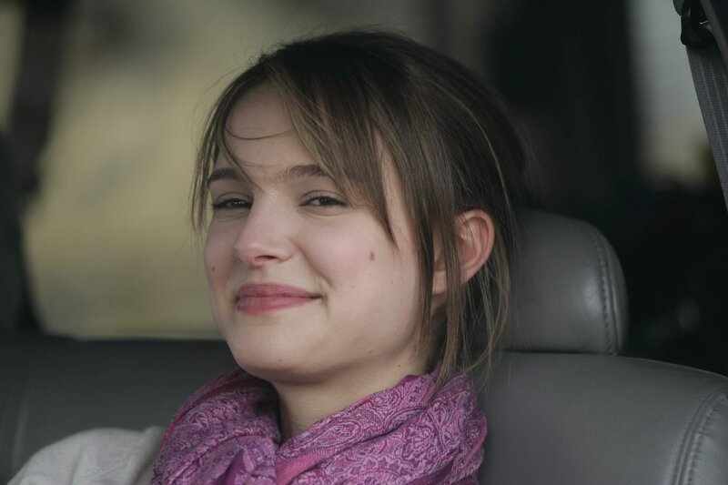 woman in car smiling