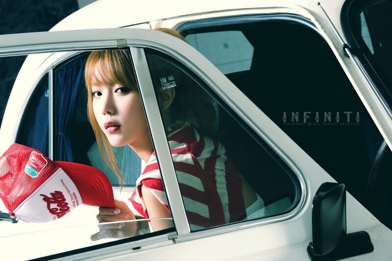 woman in car with coca-cola hat
