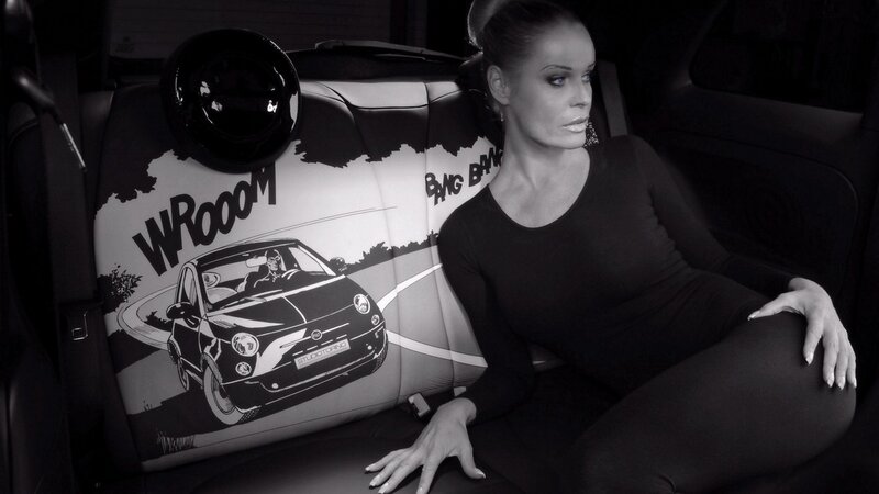 woman in car with comic seat covers