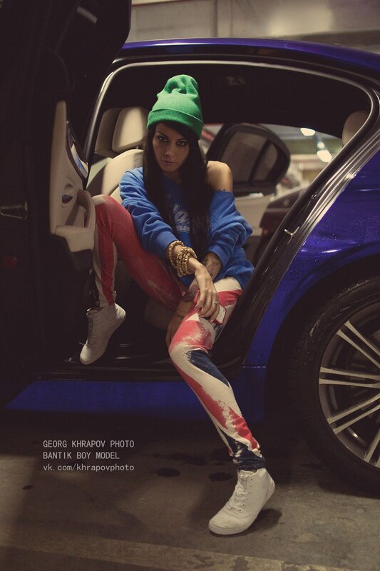 woman in car with flag pants