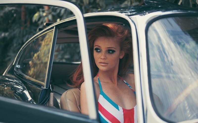 woman in car with flag swimsuit
