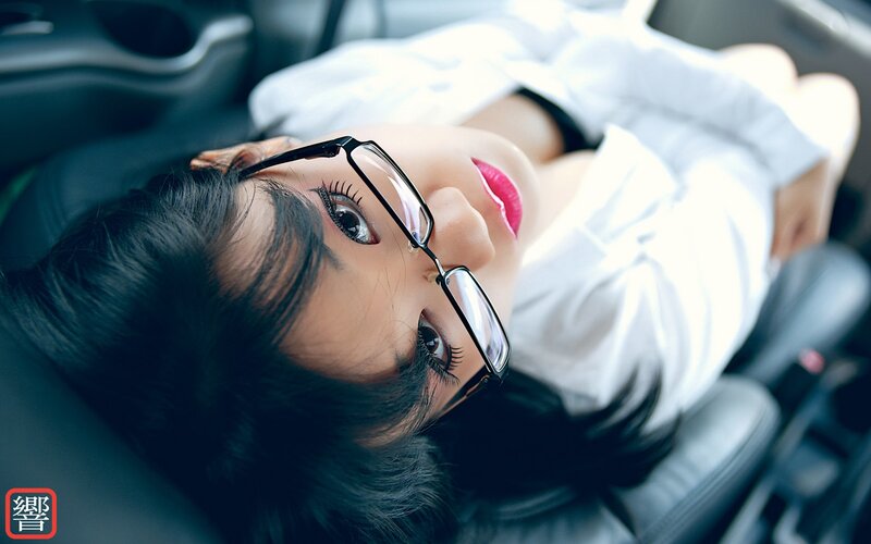 woman in car with glasses