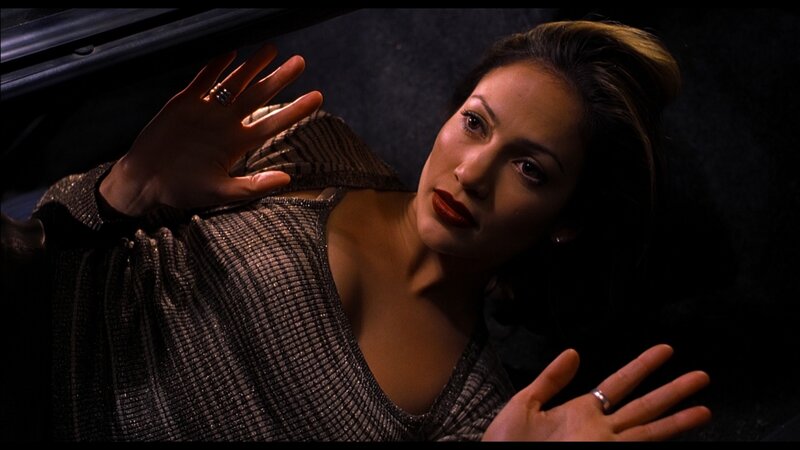 woman in car with hands up