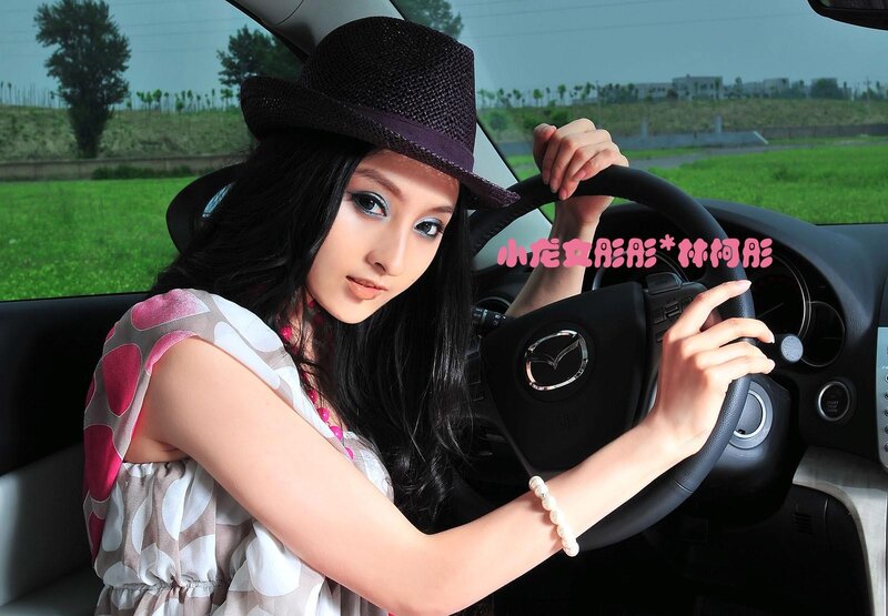 Woman in car with hat