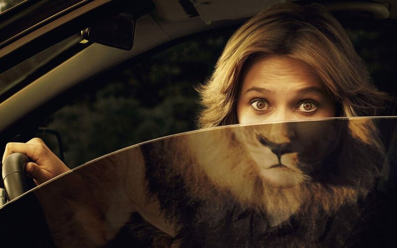 woman in car with lion face
