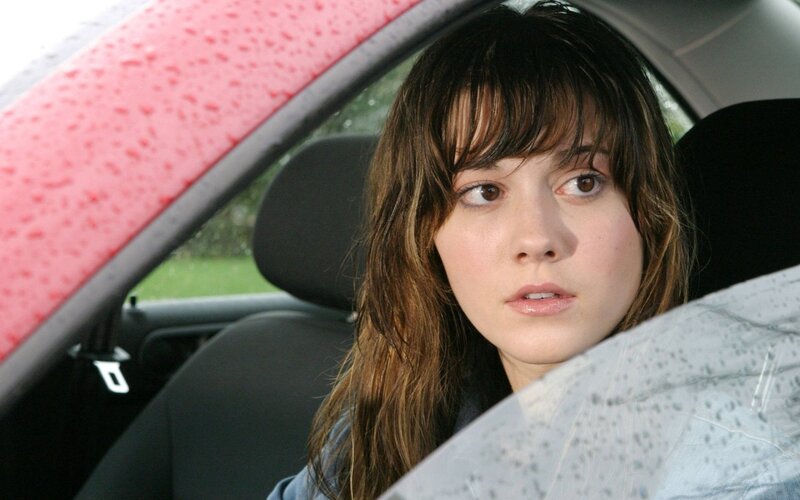 woman in car with raindrops
