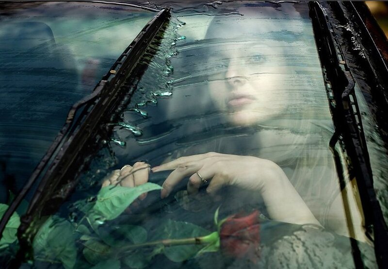 woman in car with rose