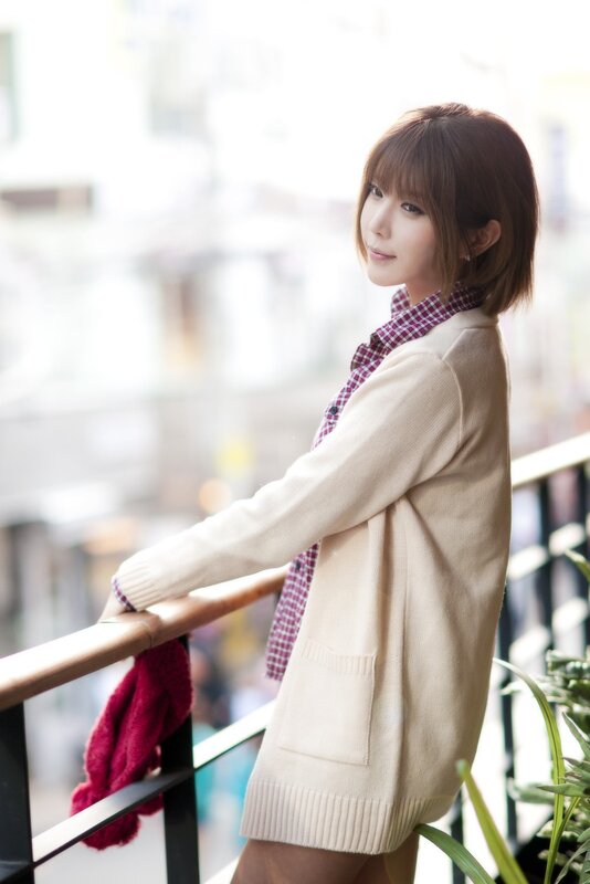 woman in cardigan on balcony