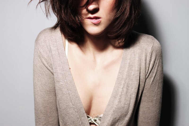 woman in cardigan with visible bra