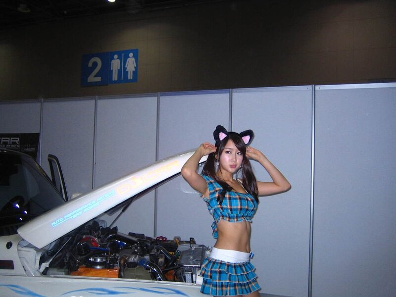 Woman in cat ears at car show