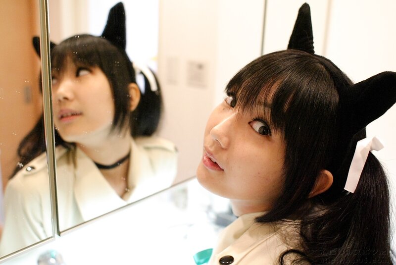 woman in cat ears looking at mirror