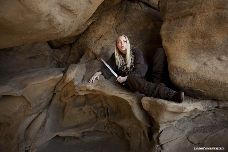 Woman in cave with sword