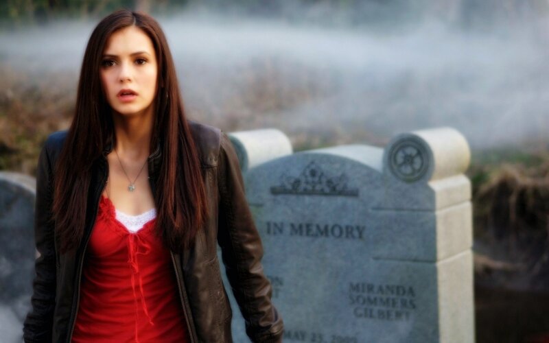 woman in cemetery with gravestone