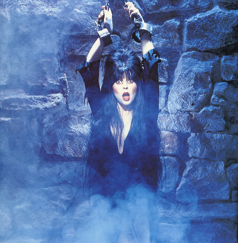 Woman in chains against stone wall