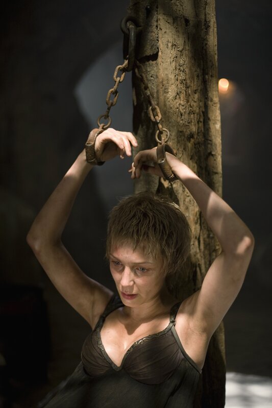 woman in chains on a post