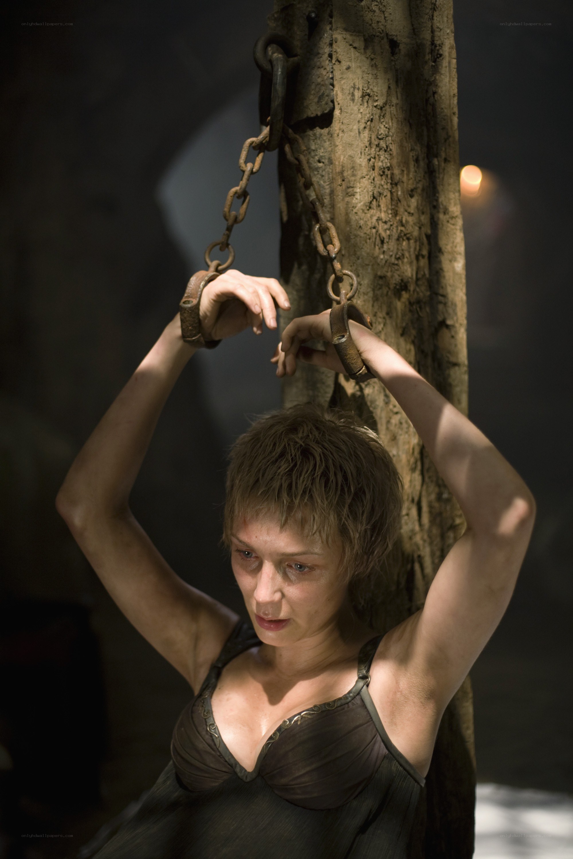 woman in chains on a post