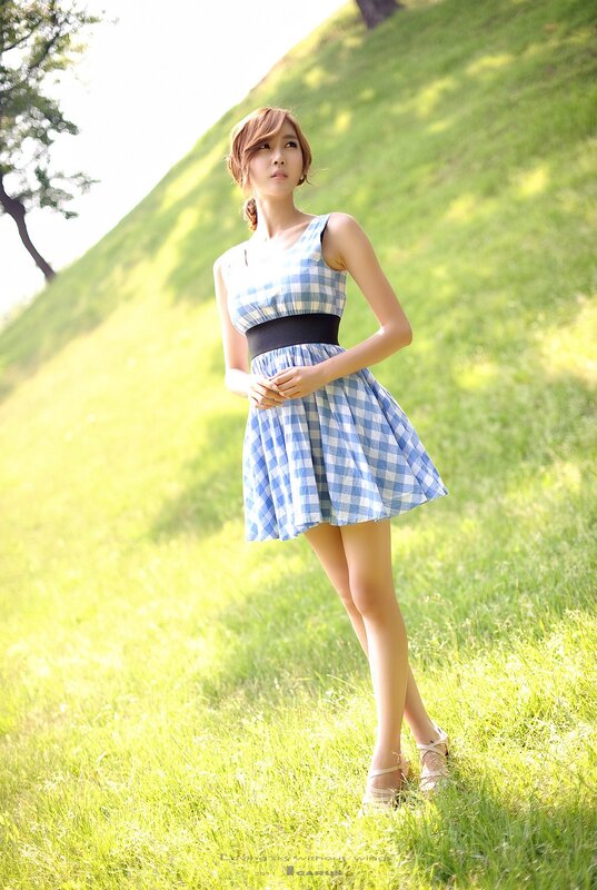 Woman in checkered dress on grass