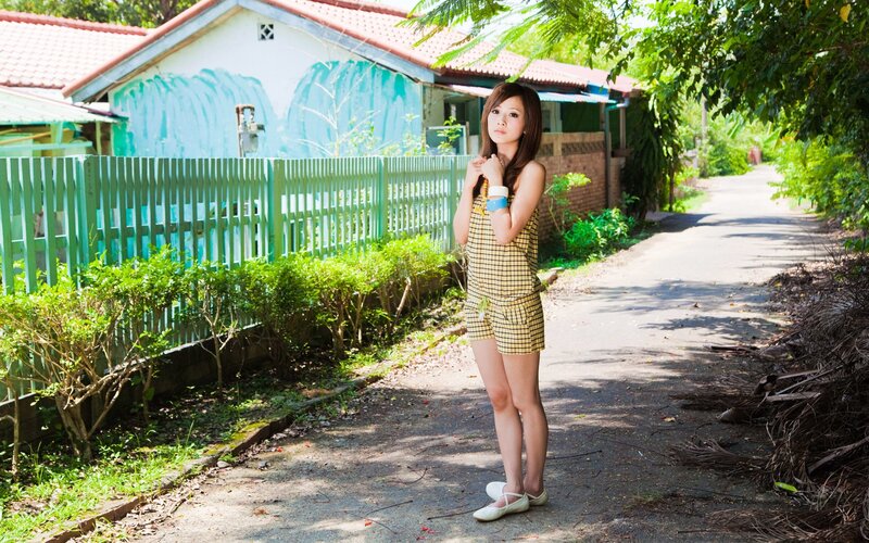 Woman in checkered dress on path