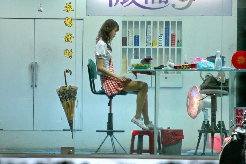Woman in checkered dress sitting