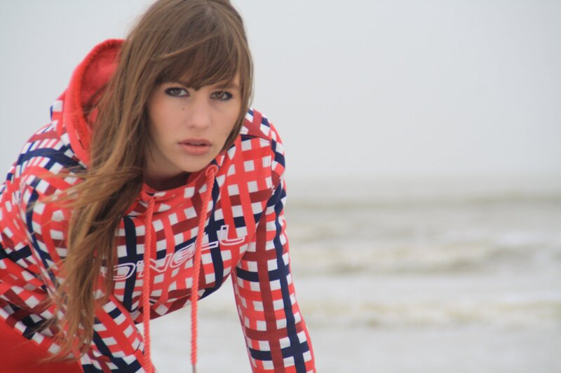 woman in checkered hoodie on beach