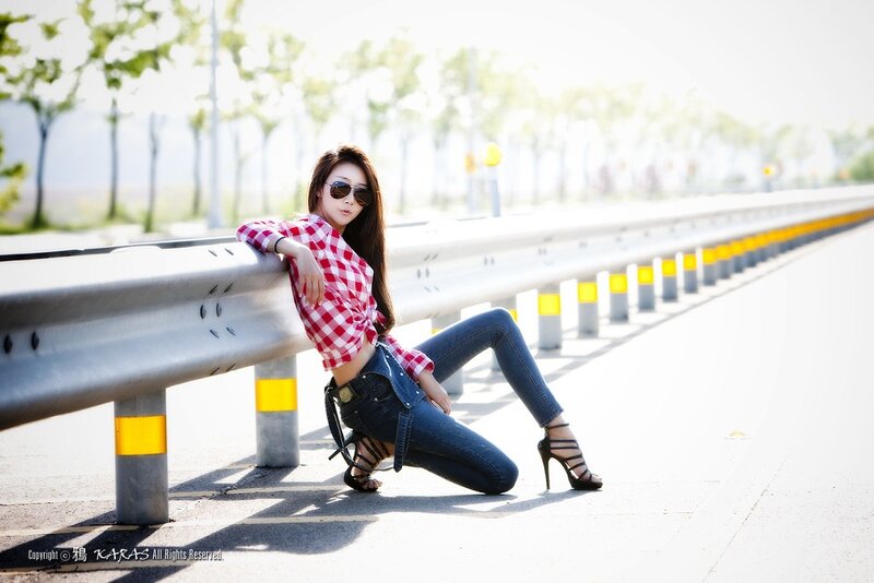 Woman in checkered shirt on roadside