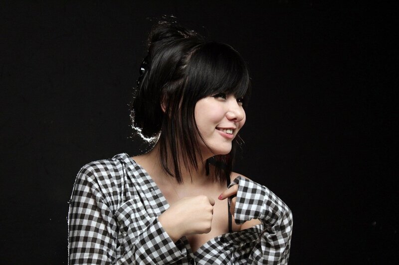 woman in checkered shirt smiling