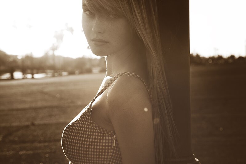 woman in checkered top at sunset