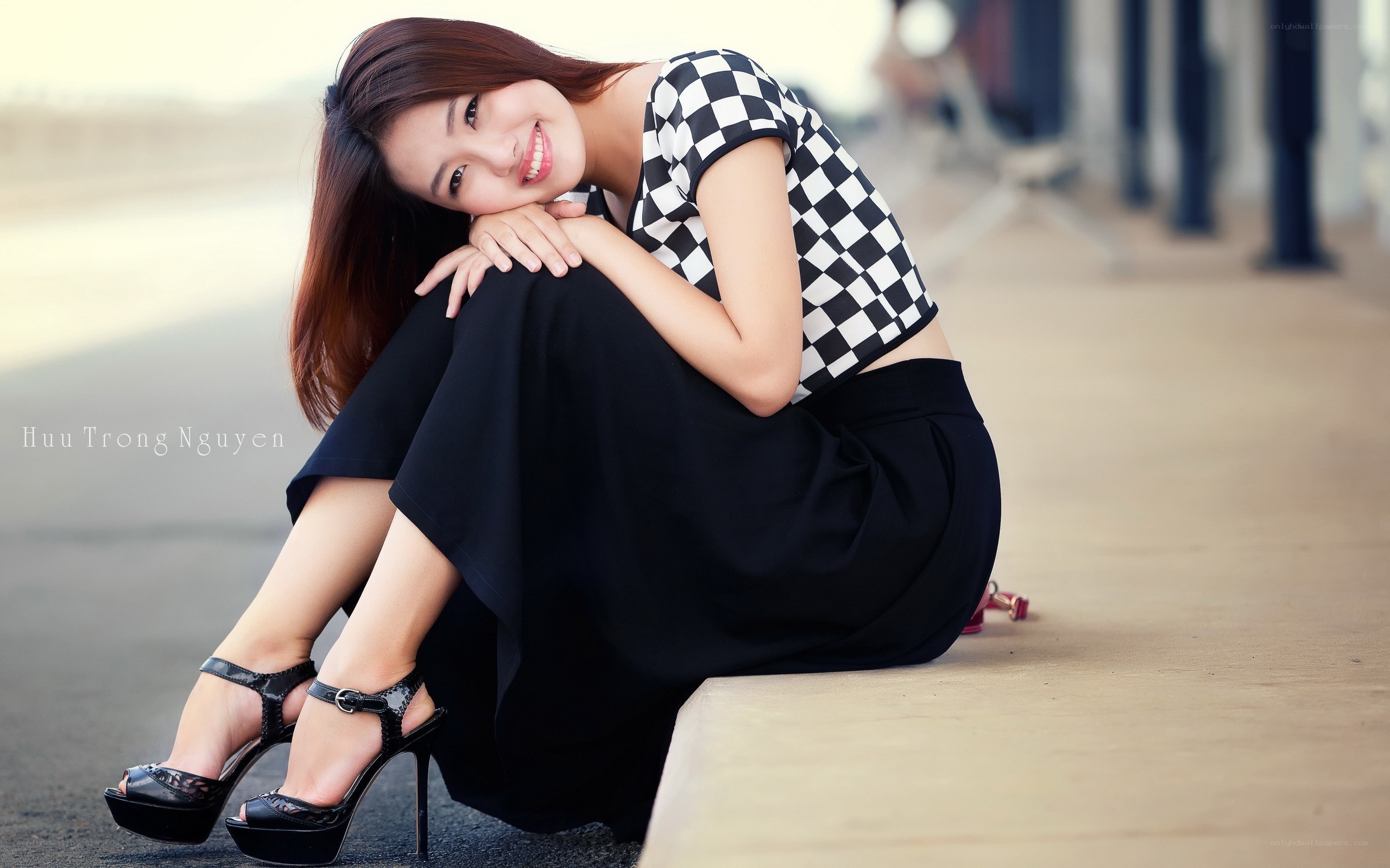 woman in checkered top sitting