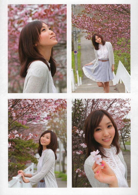 woman in cherry blossom garden