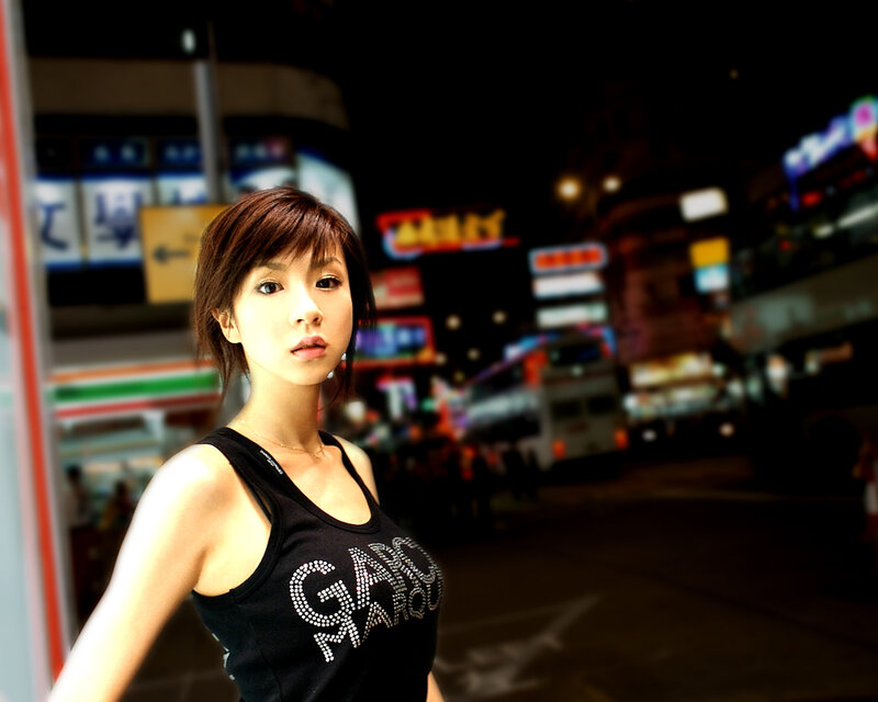Woman in city at night