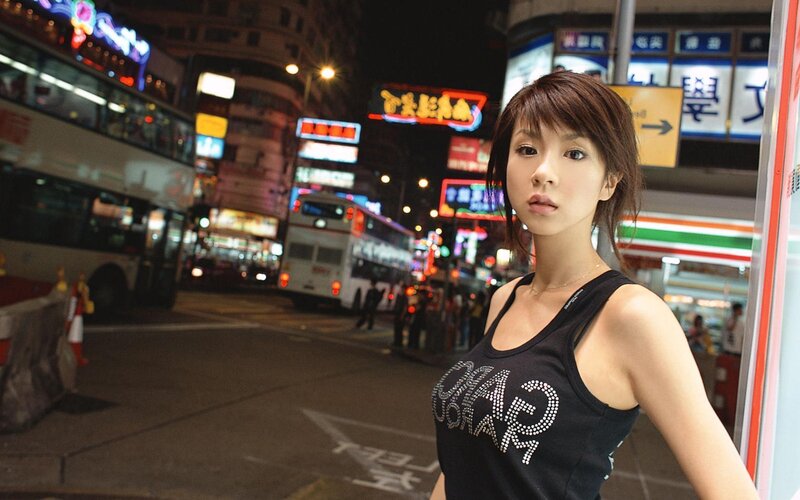 Woman in city at night