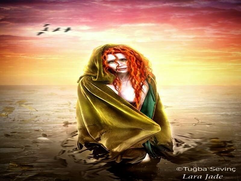 woman in cloak on beach