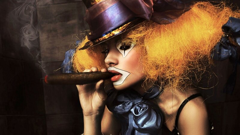 woman in clown makeup smoking cigar
