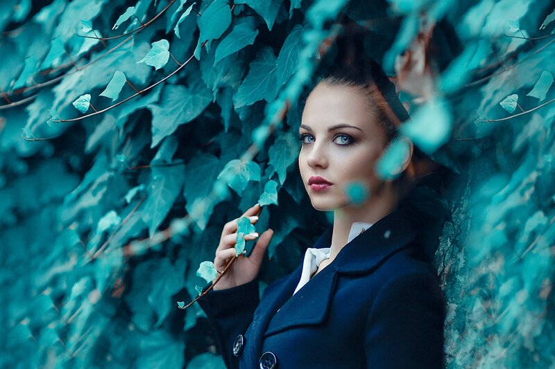 Woman in Coat Among Leaves